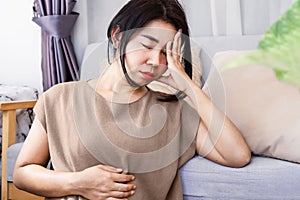 Gut-Brain Axis and anxiety concept with stress Asian woman have problems with digestion systems, stomachache, irritable bowel