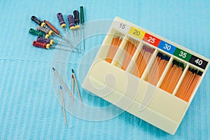 Gutta-percha pins in a set of different sizes for root canal filling, endodontic ruler close-up, material for endodontic