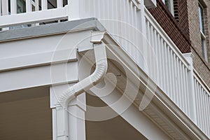 gutter with downpipe on the roof of a house