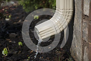 Gutter Downspout with water - side view