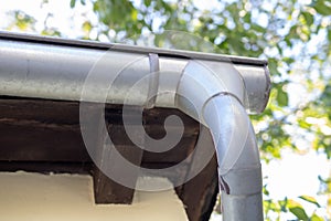 Gutter draining rainwater. The building is equipped with drainage of rainwater from the roof.