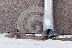 Gutter pipe against a wall background