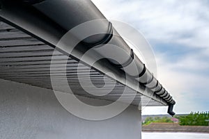 . Gutter system for a metal roof. Holder gutter drainage system on the roof