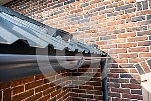 . Gutter system for a metal roof. Holder gutter drainage system on the roof