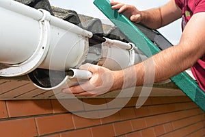 Guttering repair. Roofer contractor repair rain gutter photo