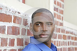 Guy against brick wall