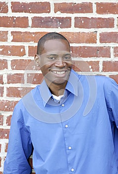 Guy against brick wall