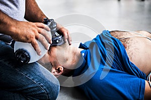 Guy assisting an unconscious man