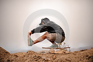 Guy with balance board on the mountain