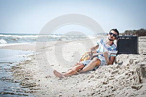 The guy on the beach with musical instruments