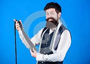 Guy with beard choosing necktie. Perfect necktie. For formal occasions choose solid colored tie that is darker than your