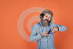 guy with beard playing video games. brutal caucasian hipster with moustache. relax at home. console controller joystick