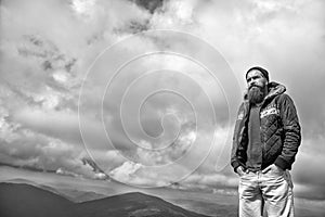 Guy or bearded man at cold weather with cloudy sky.