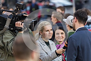 A guy being interviewed at the demonstration on Prague Wenceslas square against the current government and Babis