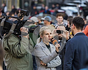 A guy being interviewed at the demonstration on Prague Wenceslas square against the current government and Babis