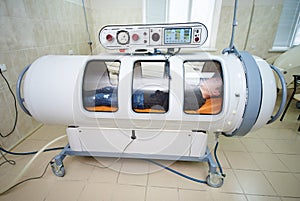 The guy in the black T-shirt lies in the hyperbaric chamber