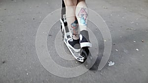 A guy on a bright, colored skateboard, tries to harness onto a concrete staircase and falls.