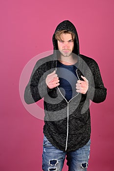 Guy with bristle in dark blue tshirt and grey hoodie.