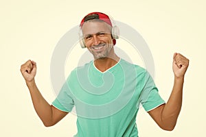 Guy in cap listen music stereo headphones. Good mood. Modern wireless headphones. Perfect sound concept. Electronic