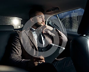 Guy in car with laptop and phone