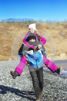 Guy carries girl on the back.