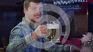 Guy cheers at the pub