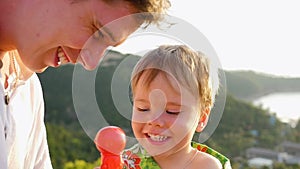 The guy with the child is playing fun, laughing. Close-up