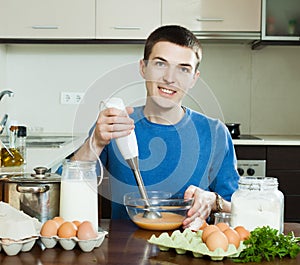 Guy cooking scrambled eggs for breakfast