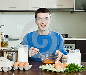 Guy cooking scrambled eggs