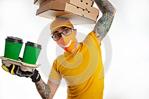 The guy delivering packages in a virus-proof mask, the courier with pizza and coffee. security during quarantine