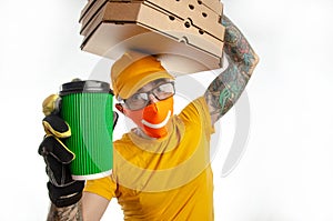 The guy delivering packages in a virus-proof mask, the courier with pizza and coffee. security during quarantine