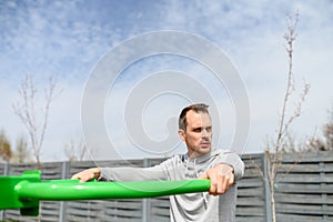 A guy is doing outdoors bar body weight workout