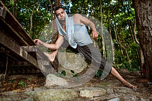 Guy doing yoga in the jungle