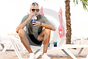 Guy drink cocktails on a tropical beach