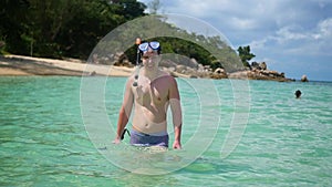 The guy enters the sea for snorkeling. Outdoor Sports. Diving