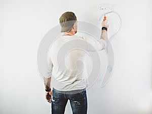 Guy erasing a question mark on a white wall