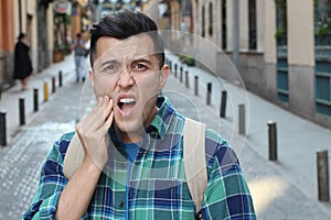 Guy experimenting intense toothache outdoors