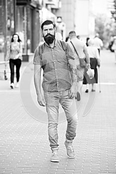 Guy exploring city. Comfortable tourism. Summer vacation. Sightseeing concept. Backpack for urban travelling. Hipster