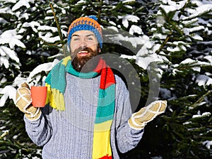 Guy with firtrees covered with snow on background. photo