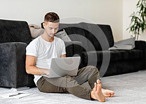 Guy freelancer working at home on the computer