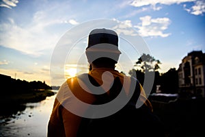 Guy in front of blue sky at evening time admire landscape. Enjoy pleasant moment. Take moment to admire sunset nature