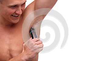 Guy with fur shaving underarm trimmer close-up on white isolated background