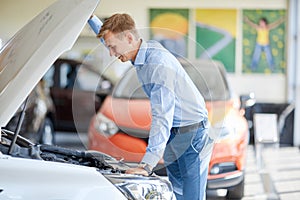 The guy with the girl came to the showroom to choose a new car.