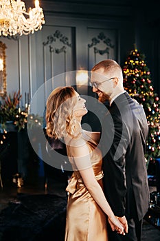 A guy with a girl is celebrating Christmas. A loving couple enjoy each other on New Year`s Eve.