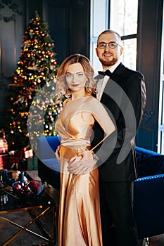 A guy with a girl is celebrating Christmas. A loving couple enjoy each other on New Year`s Eve.