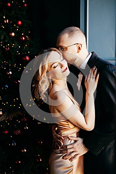 A guy with a girl is celebrating Christmas. A loving couple enjoy each other on New Year`s Eve.