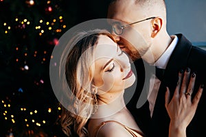 A guy with a girl is celebrating Christmas. A loving couple enjoy each other on New Year`s Eve.