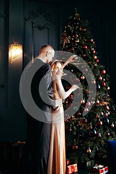 A guy with a girl is celebrating Christmas. A loving couple enjoy each other on New Year`s Eve.