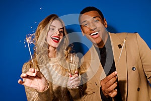 Guy and girl with champagne and sparklers