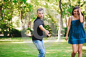 Guy and girl compete in the ring toss